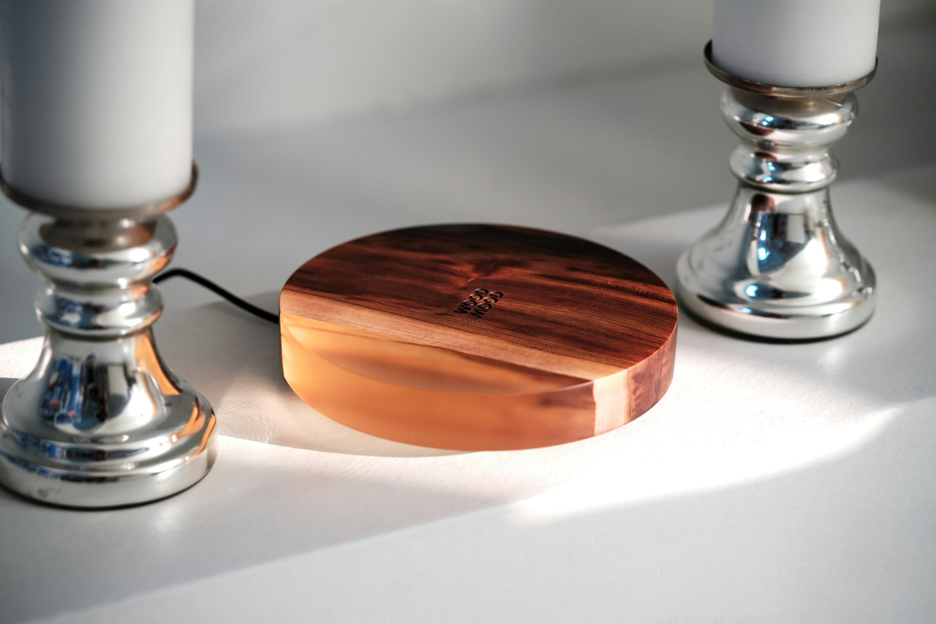 a wooden box next to two candles on a table